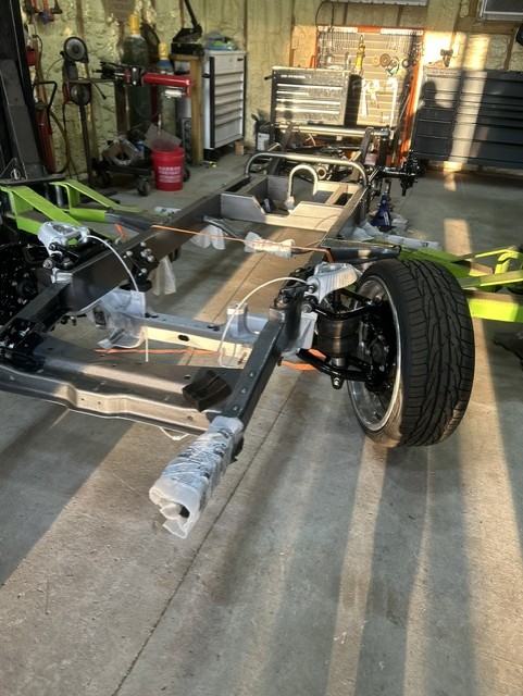 Bare custom chassis with front suspension installed during a ground-up build